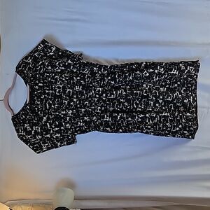 Yellow and black splotchy design dress with Tide detailing across the collar